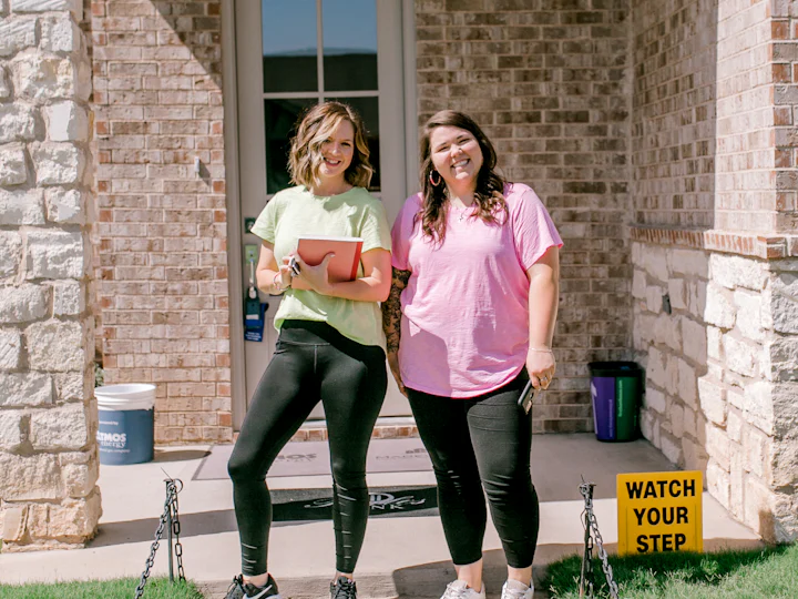 Smiling homeowners in front of their house